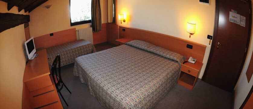 Guest bedroom with double bed, twin bed, and built-in desk