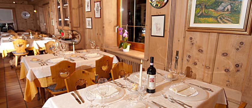 Dining area with traditional carved chairs and knotty pine paneling