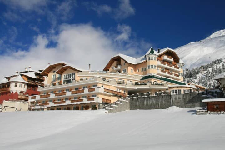 Ski-in/ski-out hotel exterior with private balconies and mountain views