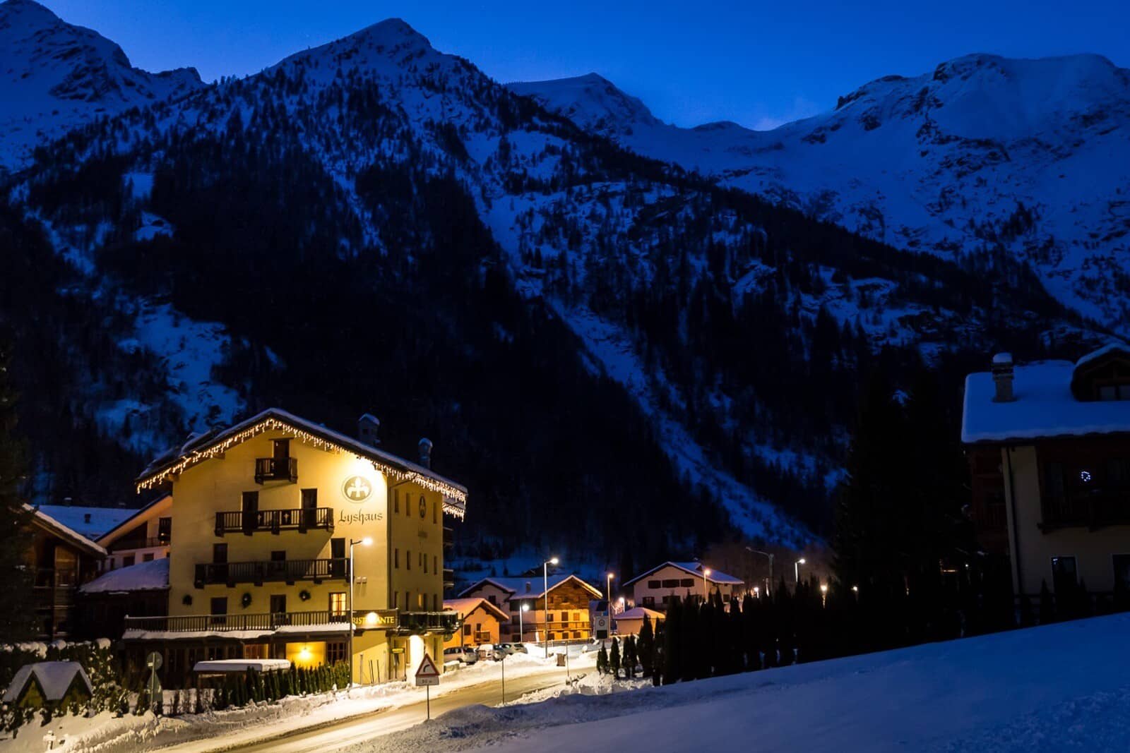 Chalet exterior at night with mountain views and proximity to town center
