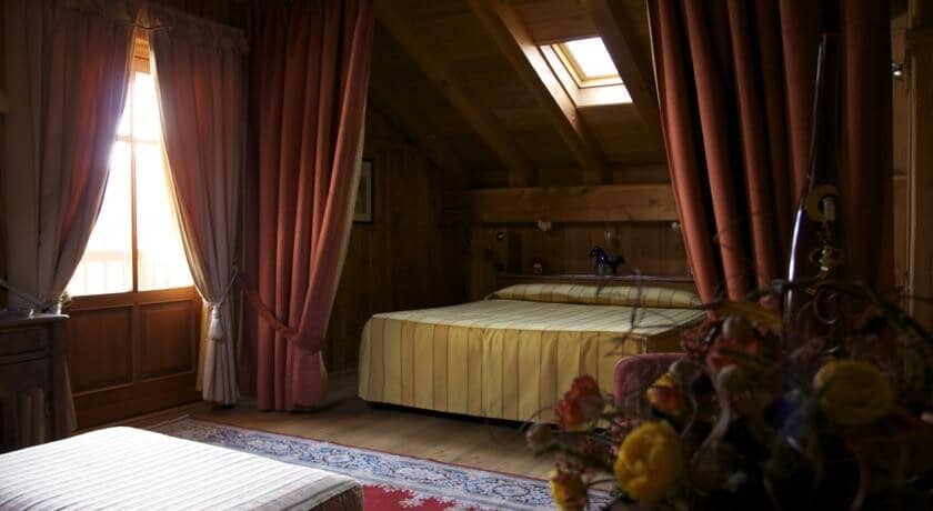 Attic bedroom with queen bed and overhead skylight window