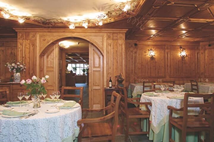 Dining room with hand-carved wood paneling and coffered ceilings