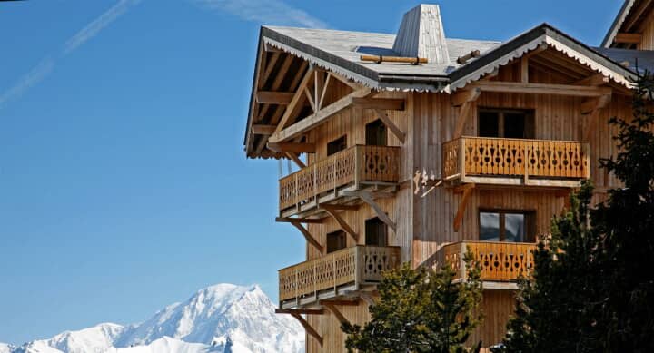 Chalet exterior with private wooden balconies and mountain views