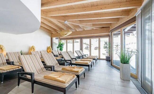 Spa relaxation room with 10 loungers and snowy mountain views