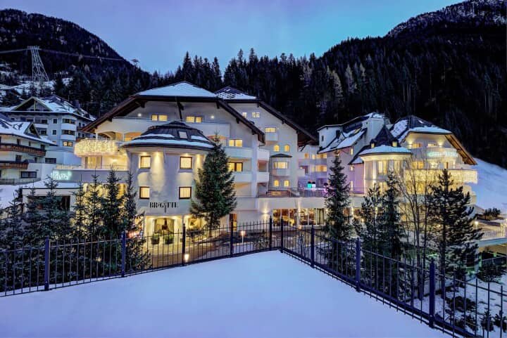 Mountain lodge with snow-covered terrace and nearby ski lift access