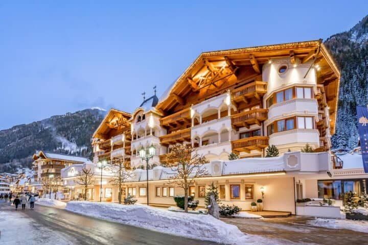 Alpine chalet exterior with private balconies and mountain views