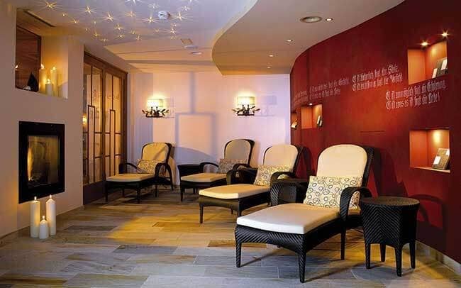 Spa relaxation room with heated tile floors and four lounge chairs