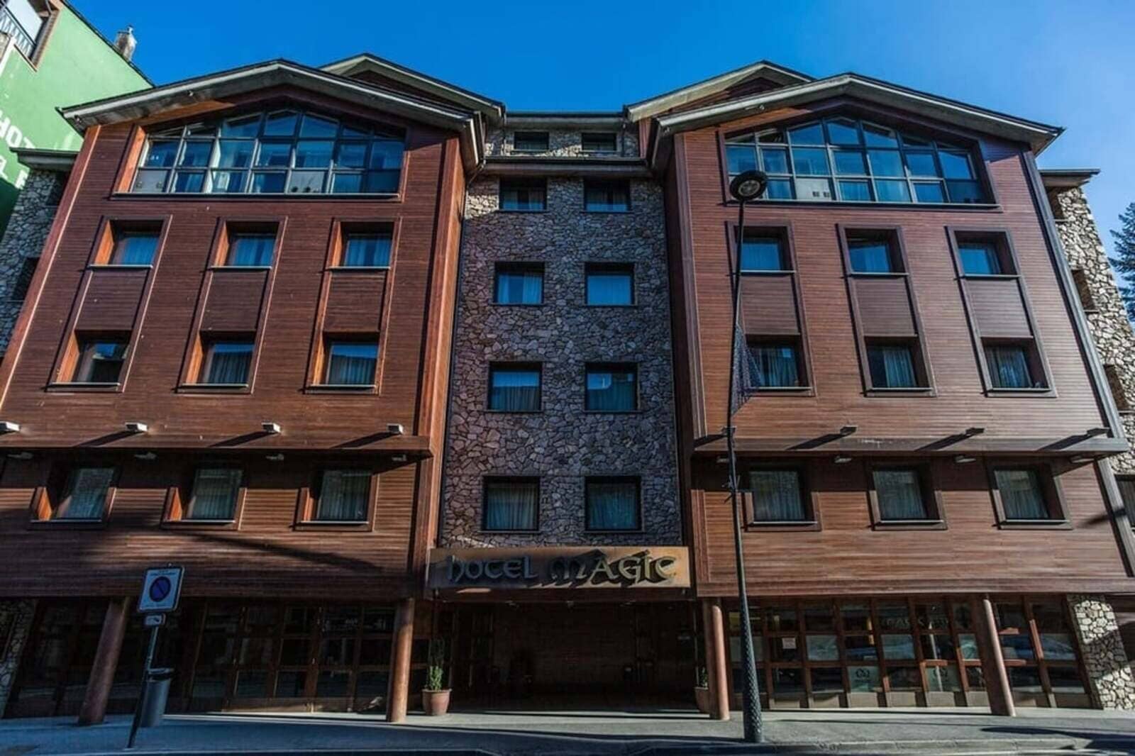 Hotel exterior featuring wood facade and stone accents