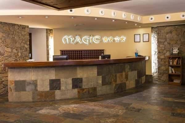 Hotel lobby reception desk with 24-hour staffing and stone tile finishes