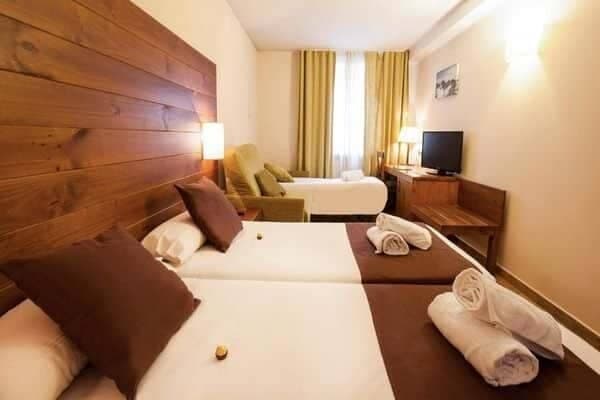 Guest bedroom with two twin beds and additional twin sofa bed