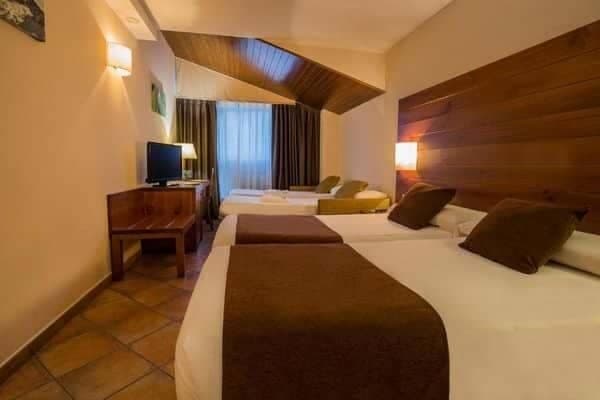 Guest bedroom with two twin beds and additional sofa bed