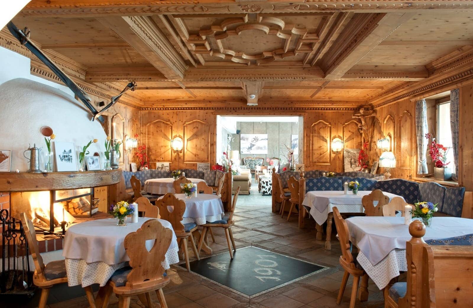 Traditional dining room with wood-paneled walls and original 1901 stone flooring