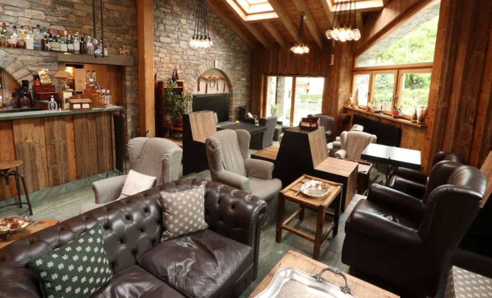Lounge and wet bar with skylights and tufted leather seating