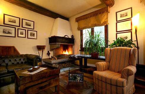Living area with wood-burning fireplace and tufted leather sofa