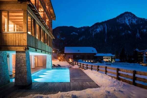 Heated outdoor pool and sundeck with alpine mountain views