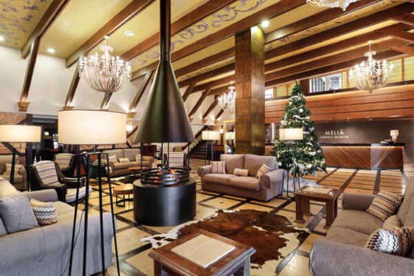 Lobby lounge featuring central 360-degree fireplace and ample sofa seating