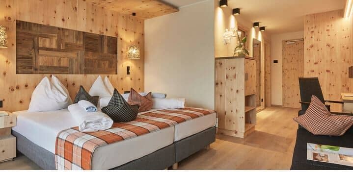 Guest suite with pine paneling and twin-joined king bed