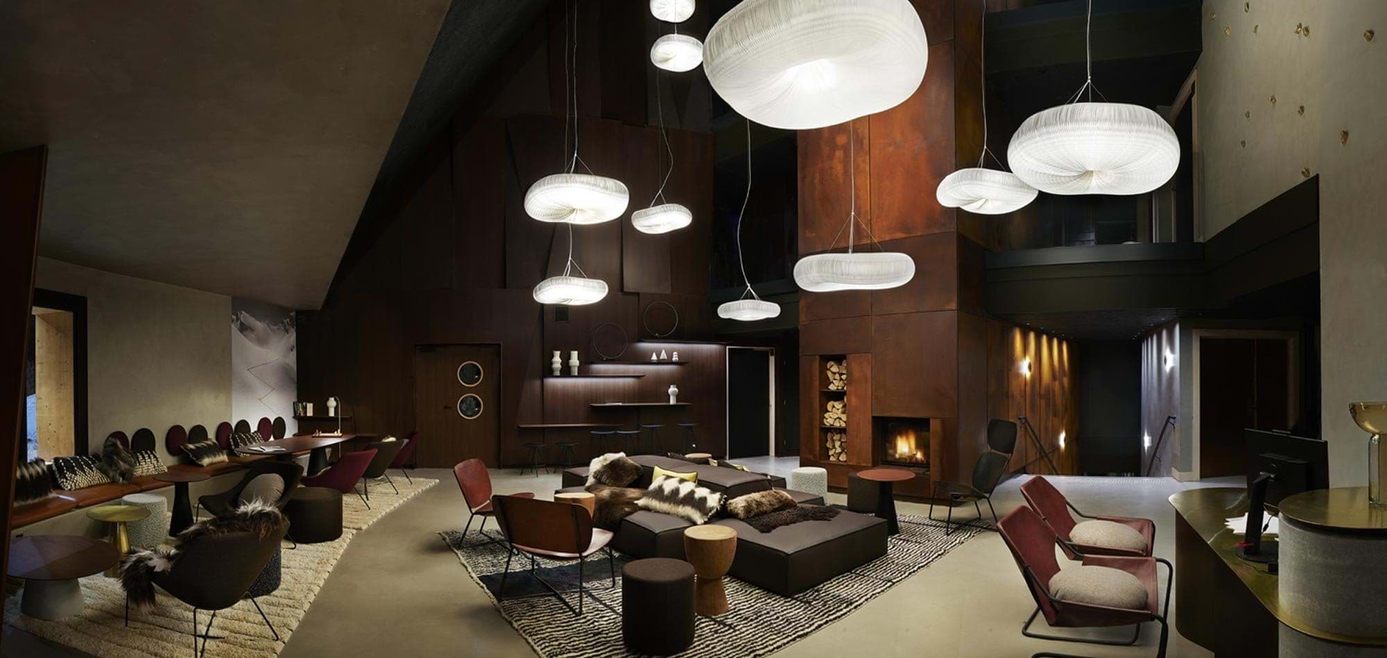 Shared lounge with wood-burning fireplace and multi-zone seating