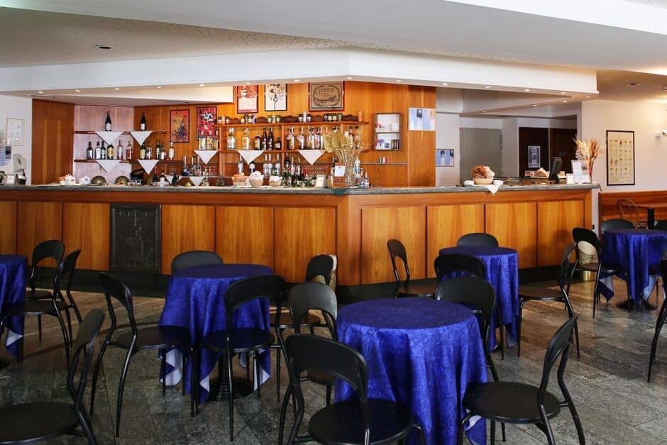 Lounge area with full-service bar and bistro table seating