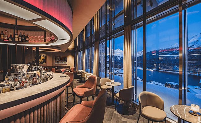 Lounge bar with floor-to-ceiling windows and lake views
