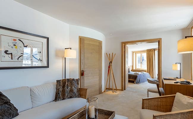 Sitting area with desk and view into adjacent bedroom