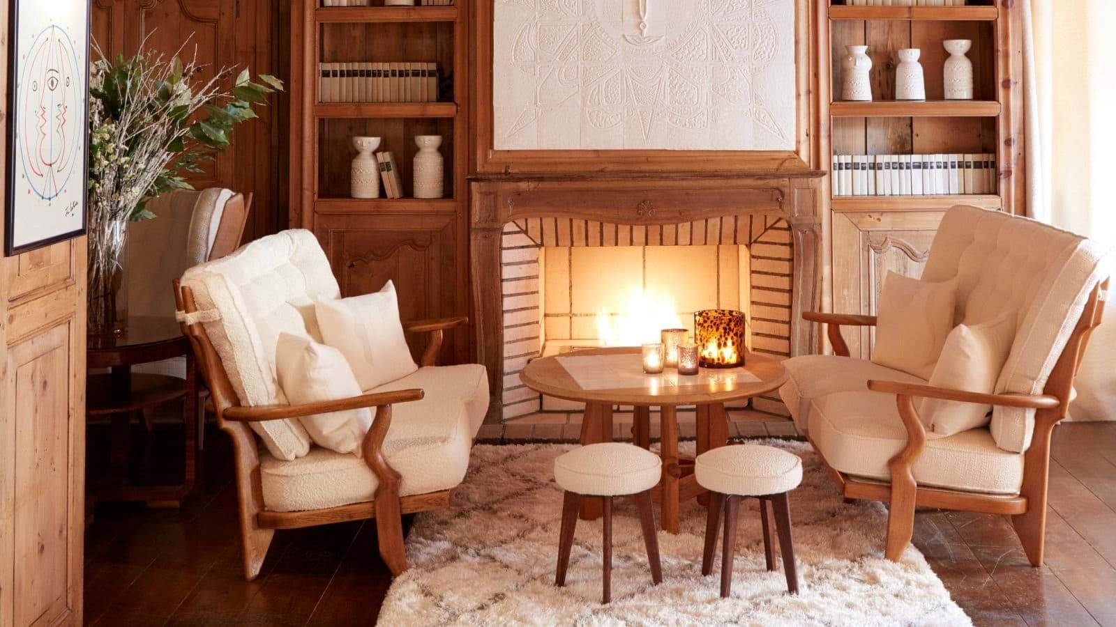 Living area with wood-burning fireplace and built-in wooden bookshelves