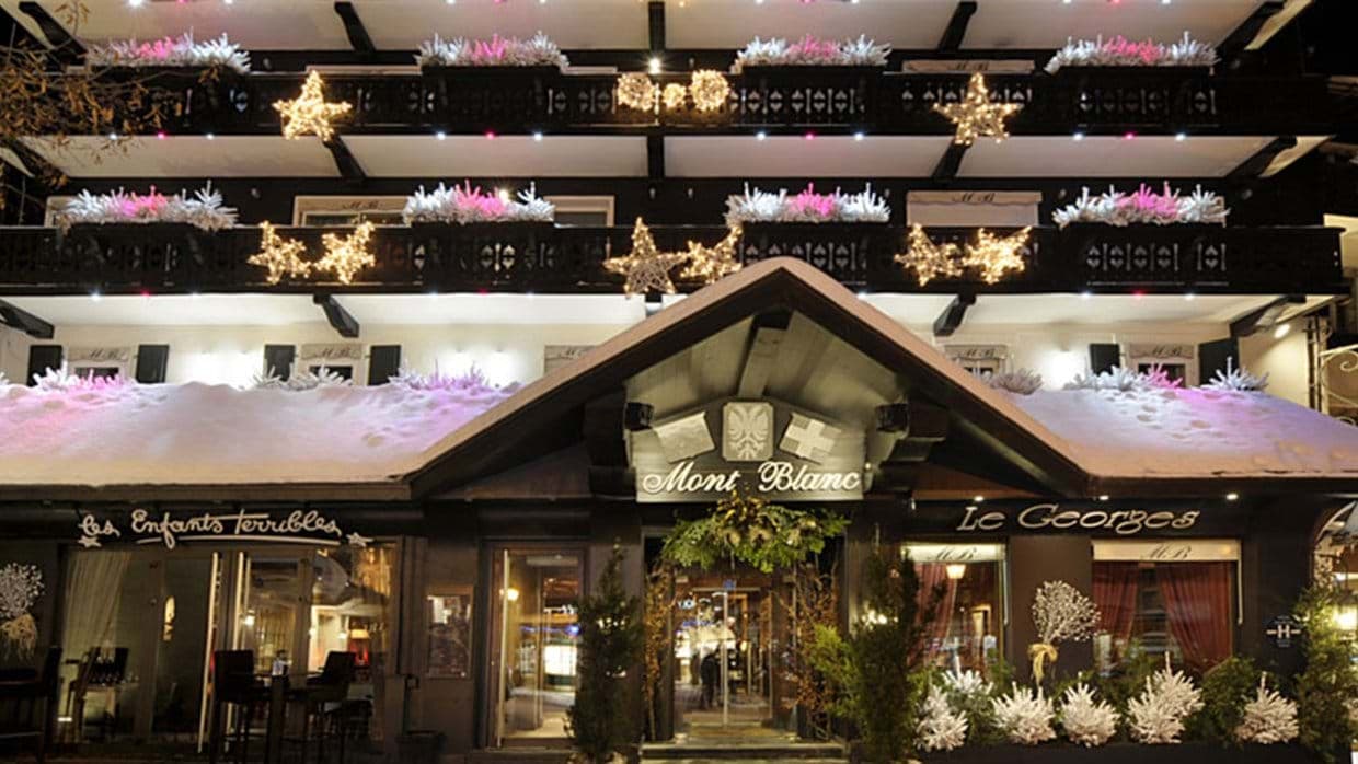 Chalet exterior with holiday star lights and ground-floor restaurant access