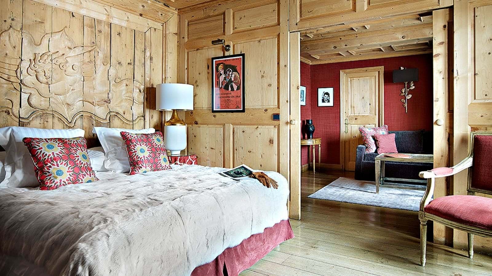 Wood-paneled bedroom with king bed and private sitting area