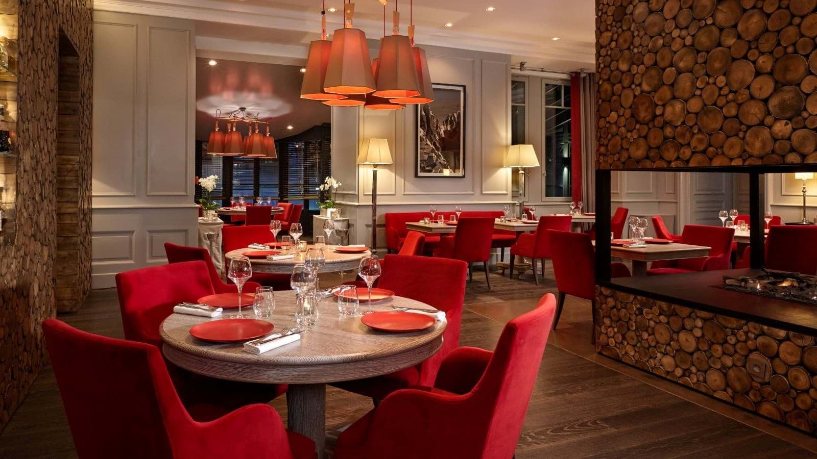 Dining area with double-sided gas fireplace and round tables