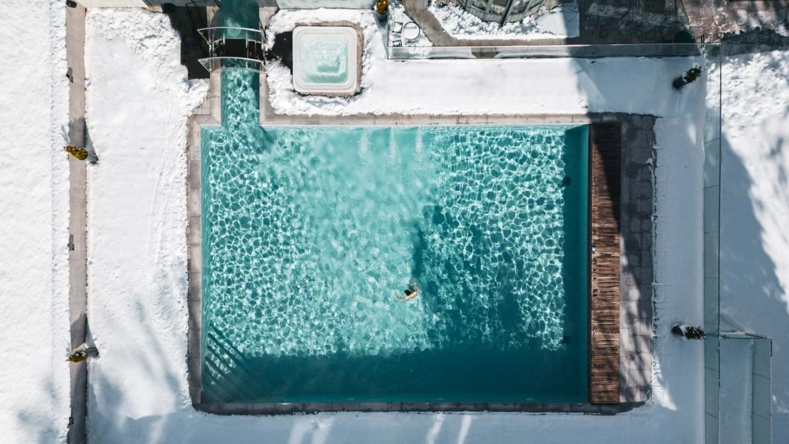 Heated year-round pool and adjacent hot tub with indoor-outdoor swim access