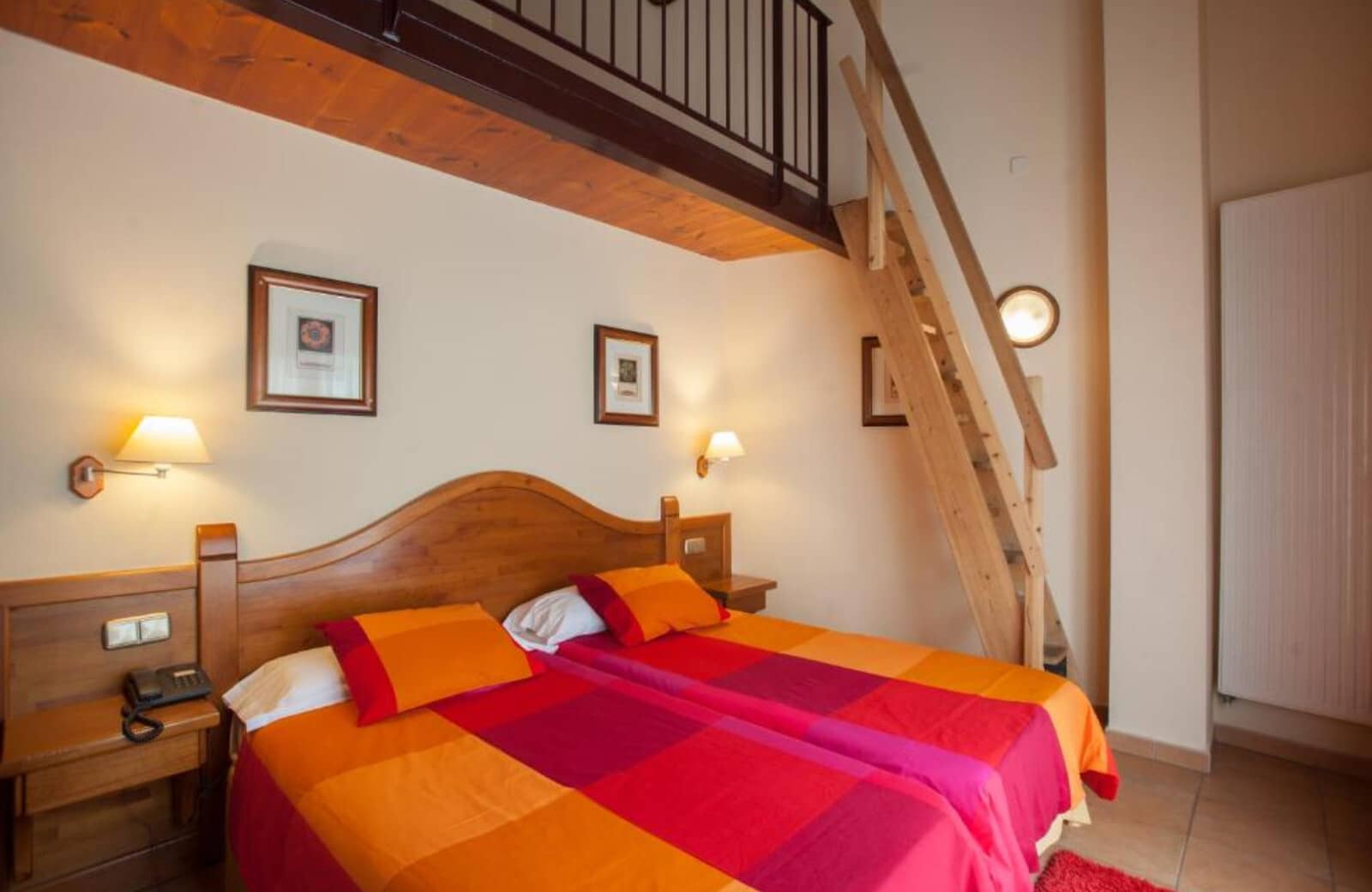 Bedroom with two twin beds and ladder access to loft area