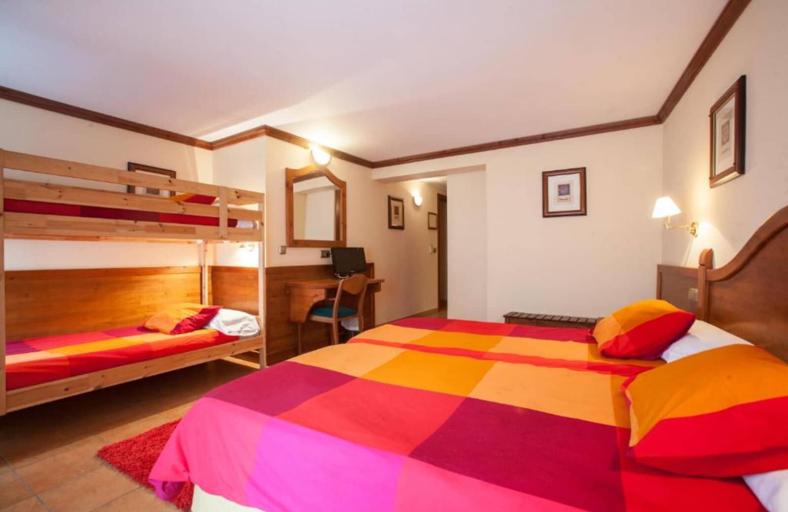 Guest bedroom with king bed, twin bunks, and built-in desk