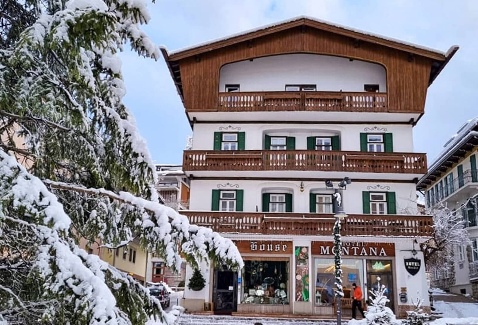 Chalet-style exterior with private balconies and ground-floor boutique shops