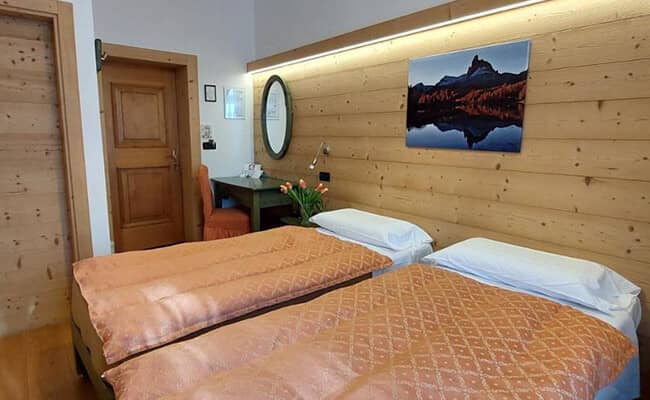 Guest bedroom with two twin beds and dedicated workspace