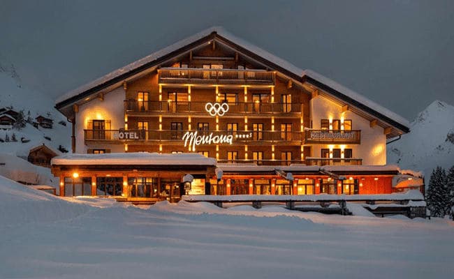Ski-in, ski-out hotel exterior featuring private balconies and on-site restaurant