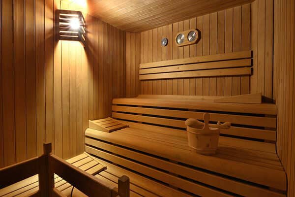 Private sauna with two-tier cedar seating and included ladle and bucket