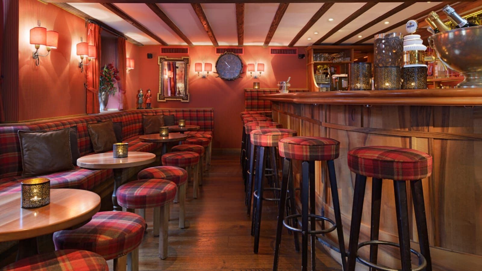 Private bar area with wood-paneled counter and plaid banquette seating