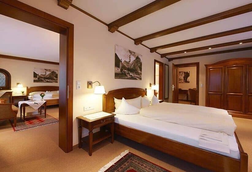 Family suite with connecting bedrooms and exposed timber ceiling beams