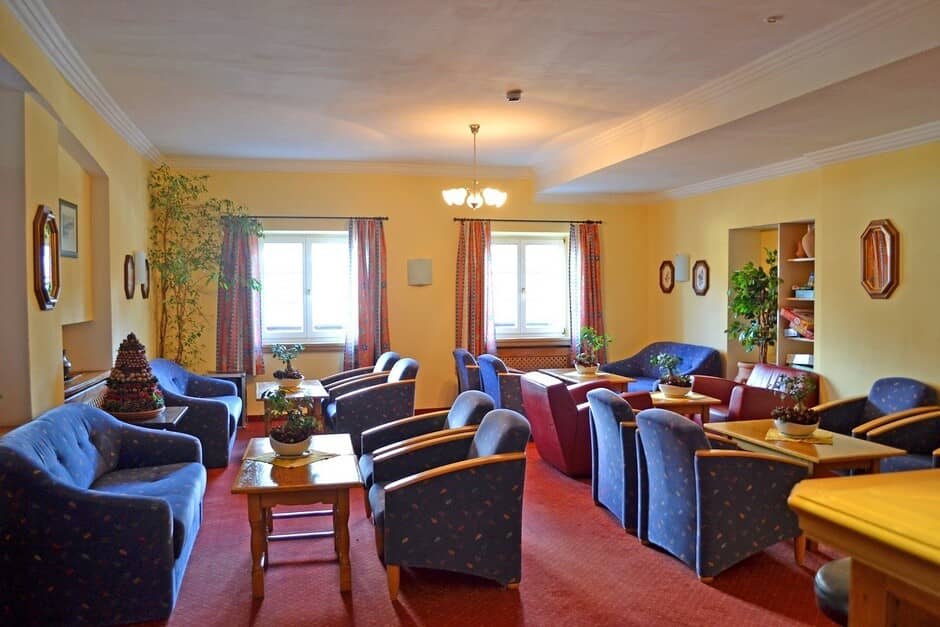 Shared lounge area with multiple armchairs and board game library