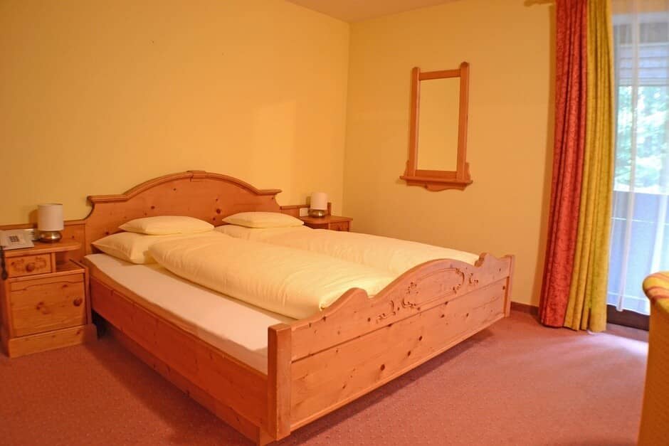 Guest bedroom with pine wood frame and king bed