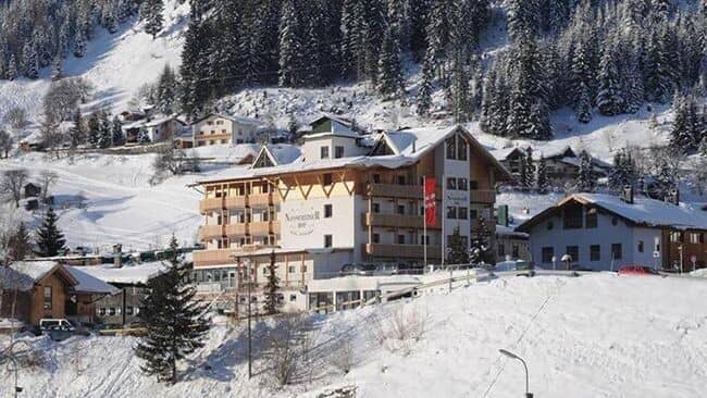 Ski-in/ski-out hotel exterior with private balconies and mountain views