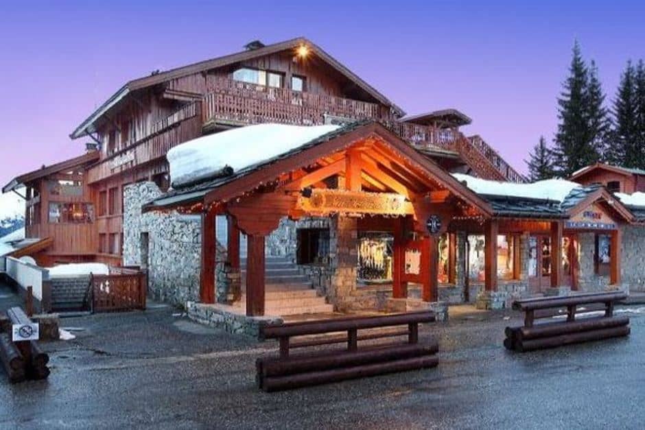 Chalet exterior featuring ground-floor ski rental and equipment shops