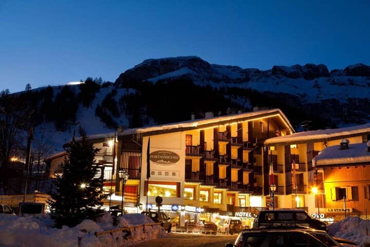 Portavescovo building exterior at night with direct access to ski slopes