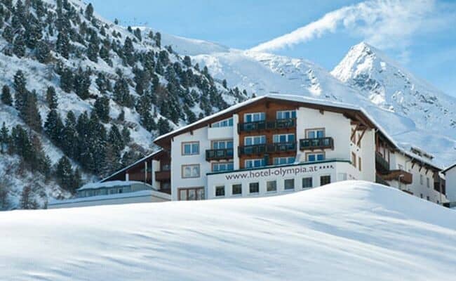 Ski-in/ski-out hotel exterior with private balconies and mountain views