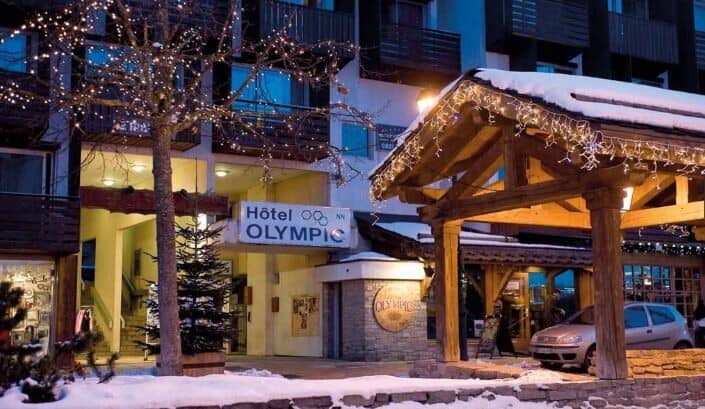 Hotel Olympic exterior with pedestrian entrance and covered parking area