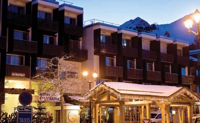 Ski-in lodge exterior with private balconies and mountain views