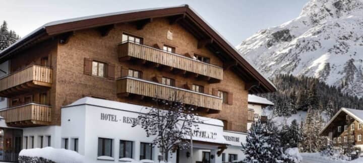 Chalet exterior with multiple private balconies and mountain backdrop