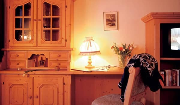 Built-in pine desk area with library shelving and television