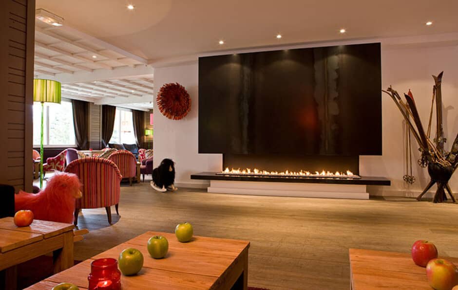 Lounge area with linear gas fireplace and armchair seating