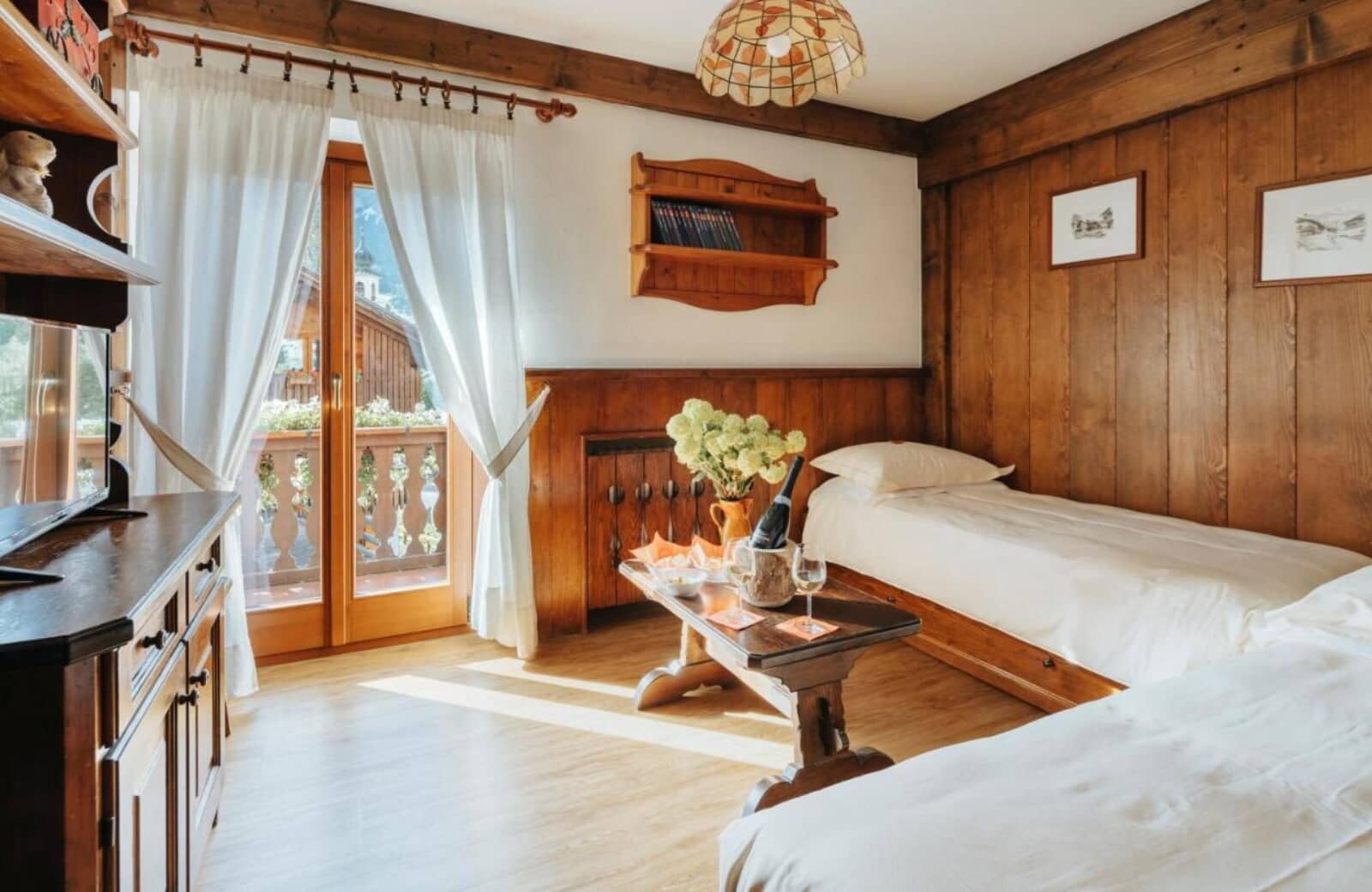 Guest bedroom with twin beds and private balcony access